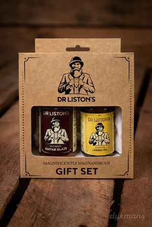 Dr. Liston's Guitar Glaze & Lemon Oil Set op een warme houten achtergrond